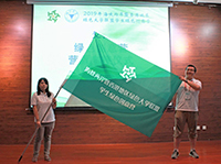 A student representative of Zhejiang University (right) passes the activity flag to another student of National Central University (NCU) to signify NCU's hosting of the event next year